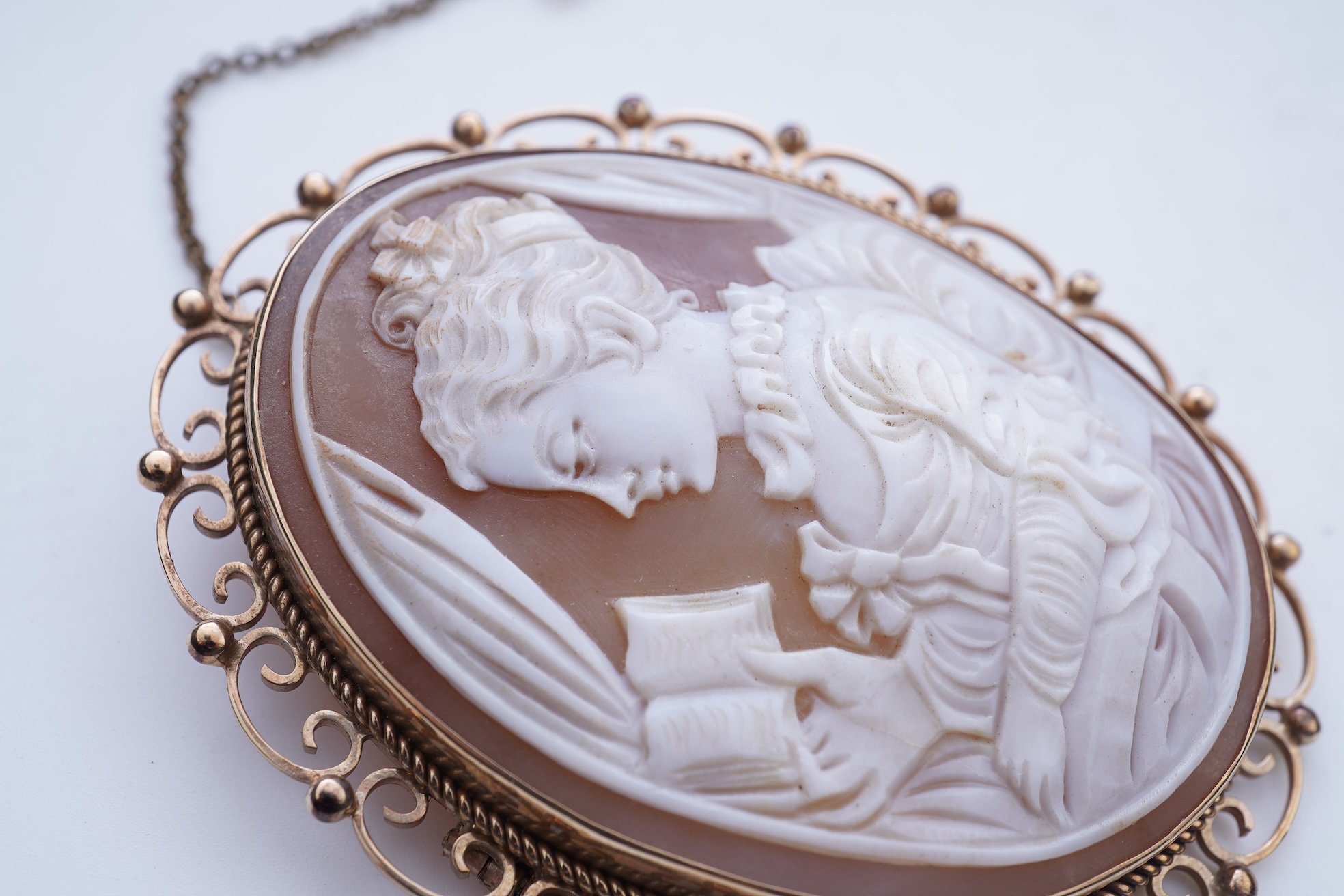 A shell cameo brooch and a gold and cultured pearl brooch